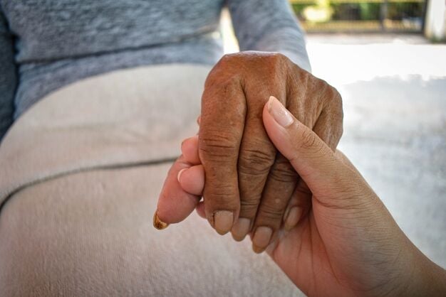 Grandma and grandson hold hands, showing love in the family